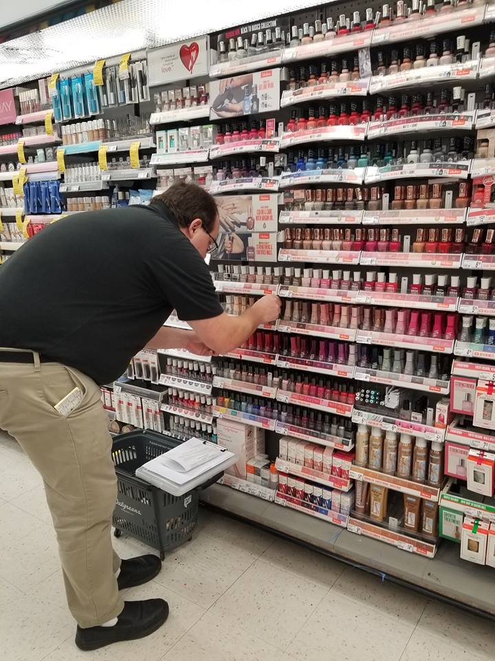 A merchandising team member perfects a display