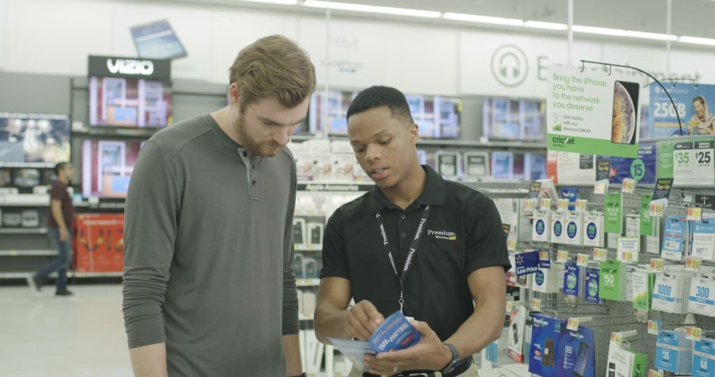 A Premium Walmart Wireless employee helps a customer