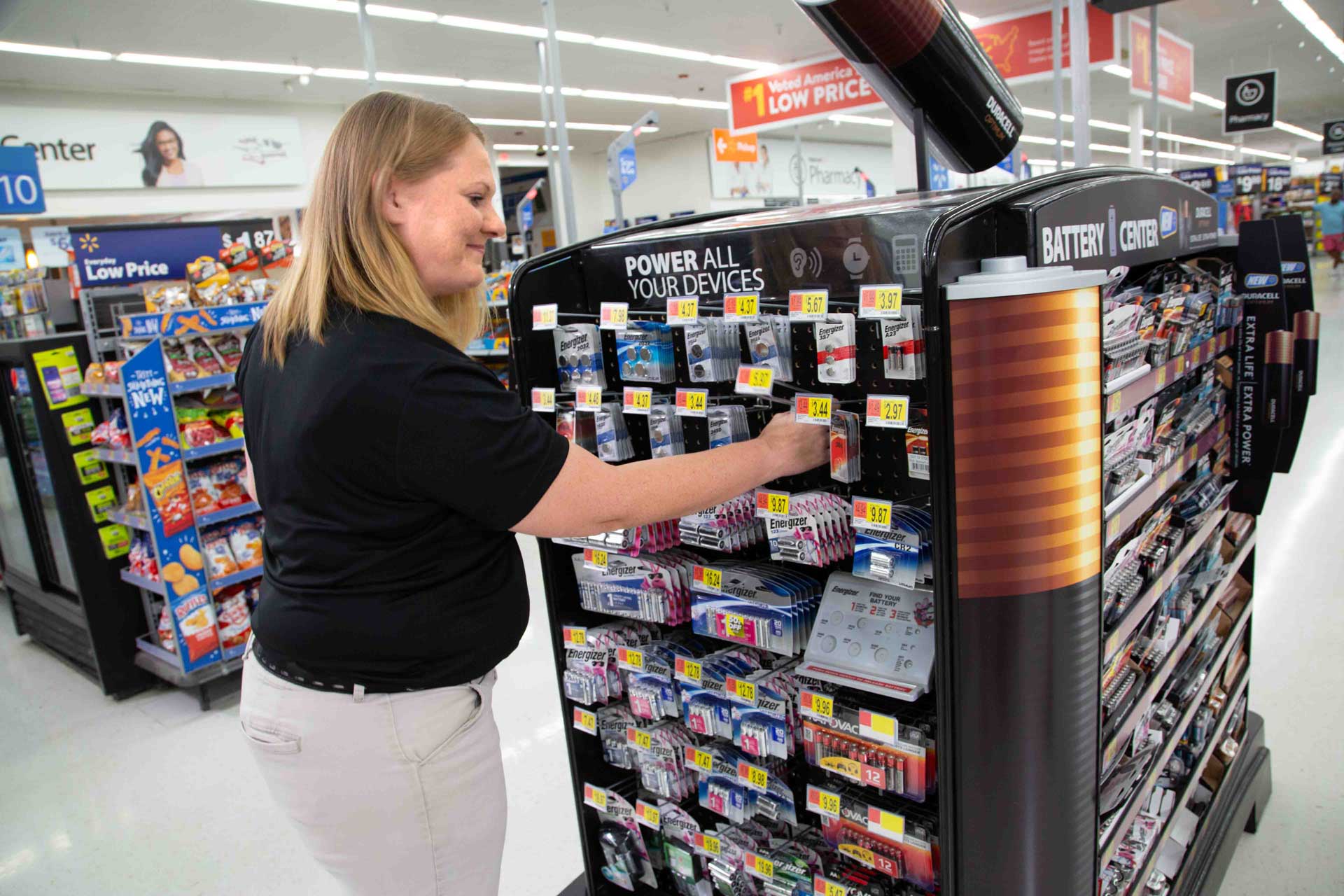Premium employee reviews a Duracell display in store