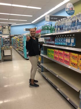 A merchandising team member reviews a display