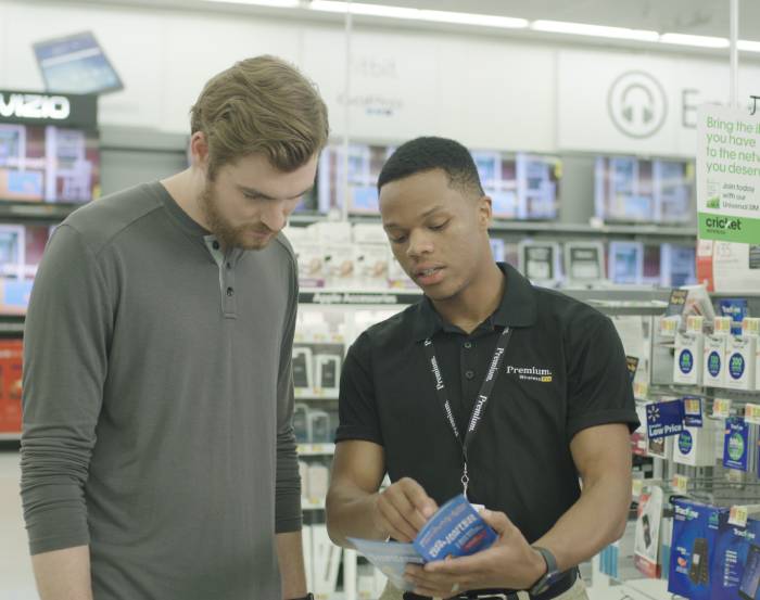 Premium Walmart Wireless team member helps a customer